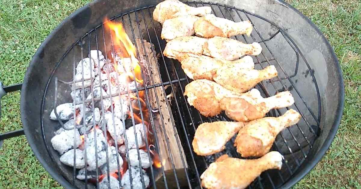 adding chicken to the grill